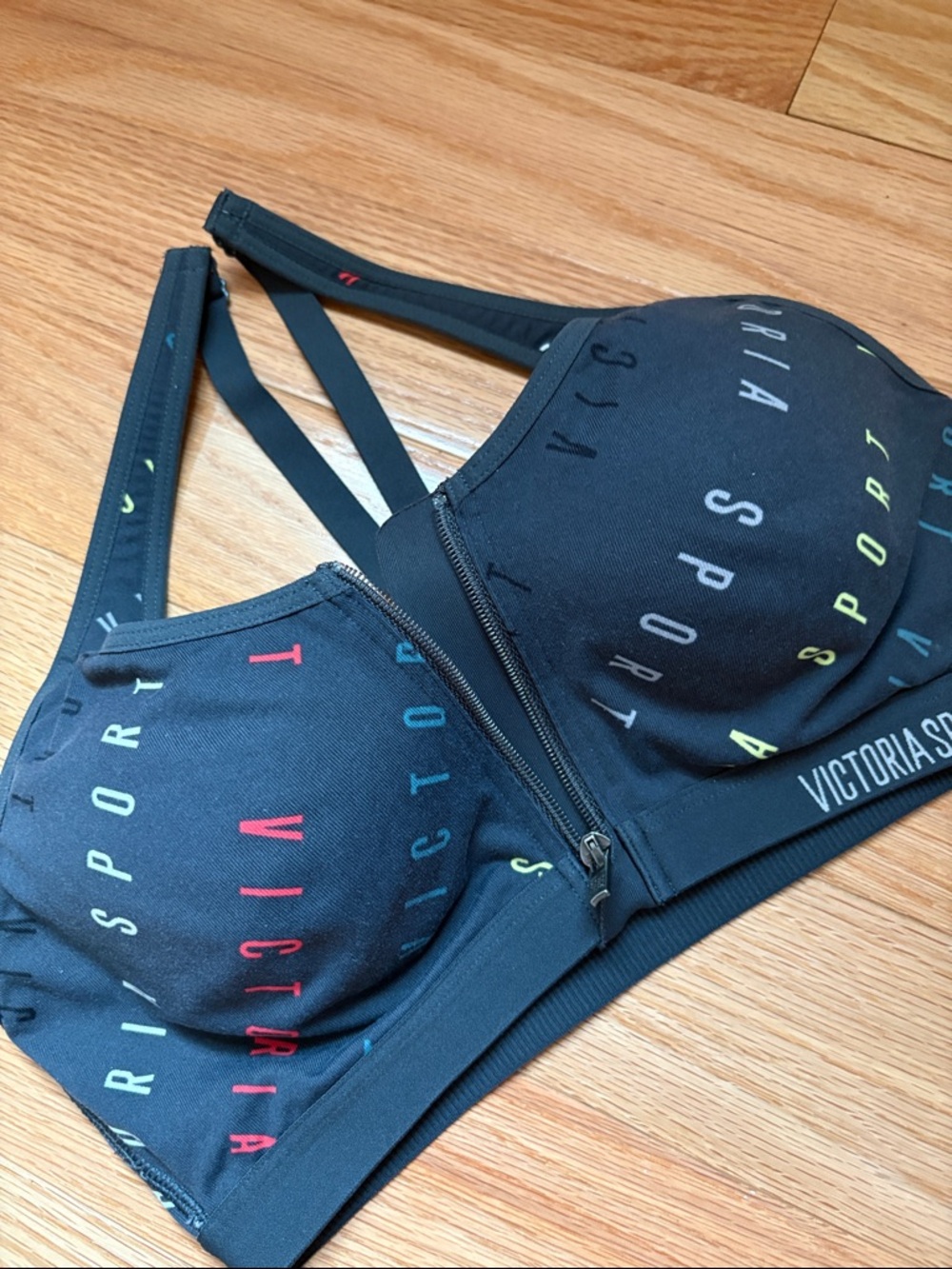 Victoria Sport Zip-Front Black Sports Bra with Multicolor Logo
